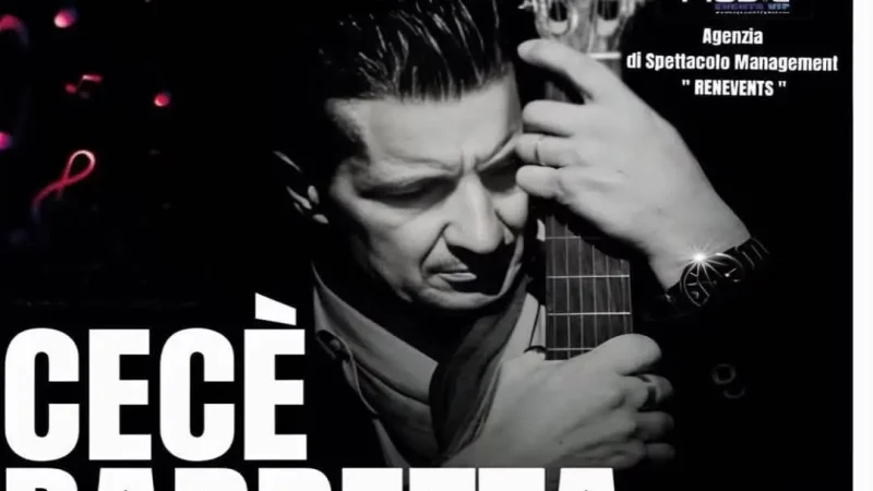 l'immagine mostra l'artista cecè barretta che abbraccia la chitarra
